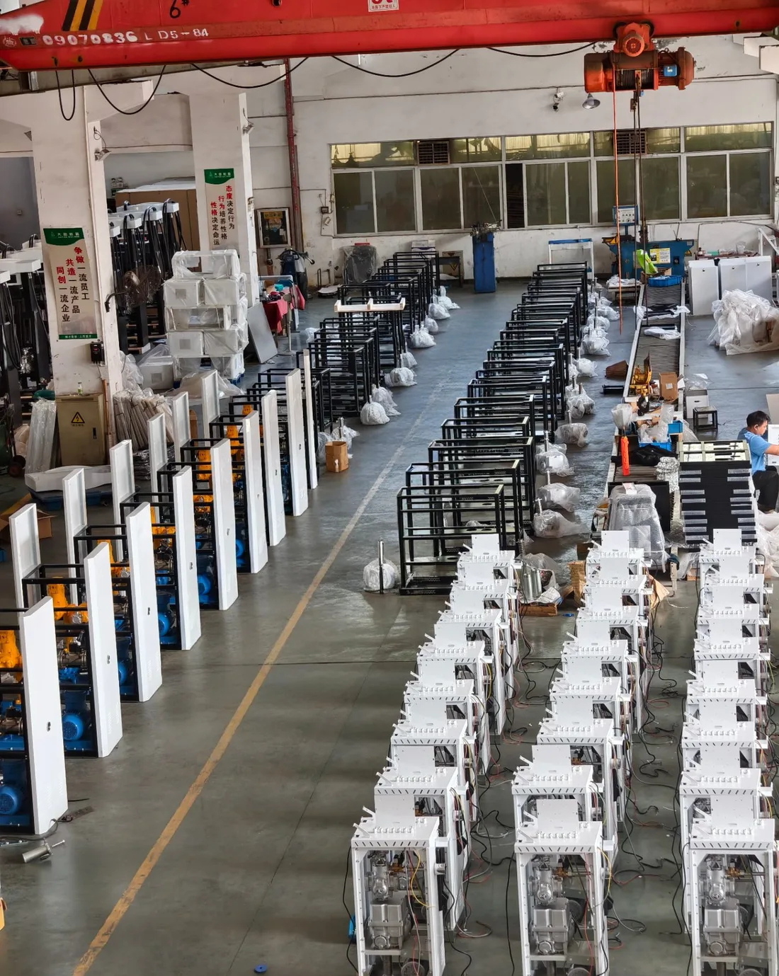Dispenser frames and pump assemblies staged on the production floor