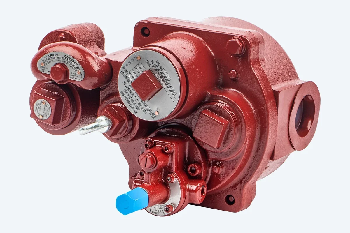 DT-STP discharge head during assembly: manifold face, lifting eye, electrical connector and line check valve on a cast red body
