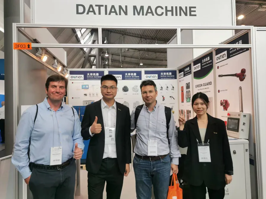 Two visitors with Datian staff at the Datian Machine stand, UNITI Expo 2024
