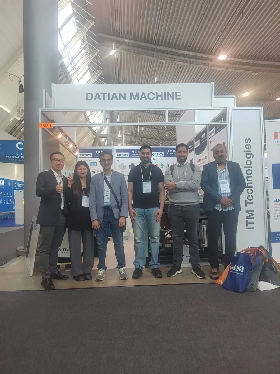 Group photo of visitors and Datian Machine staff at booth 3F03, UNITI Expo 2024