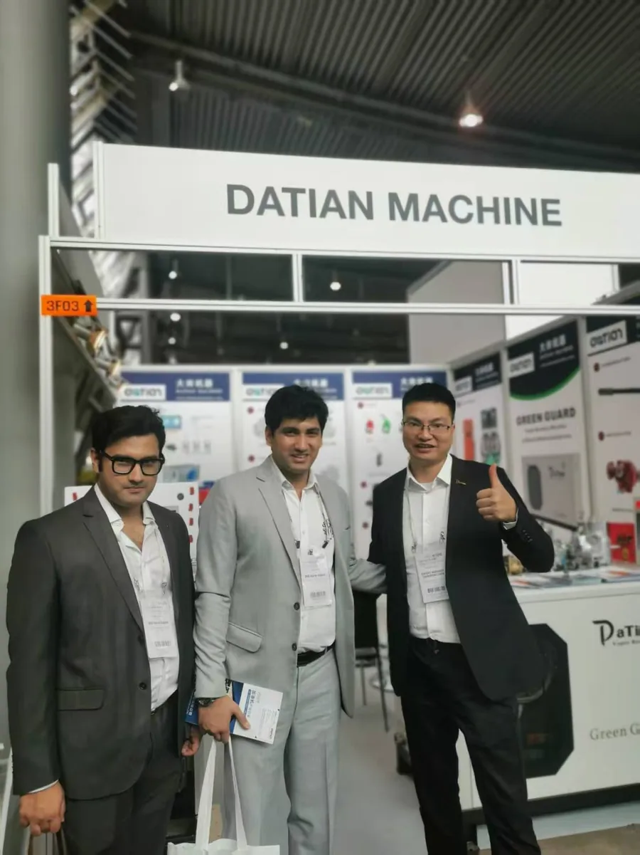 Two visitors with Datian staff at booth 3F03, UNITI Expo 2024