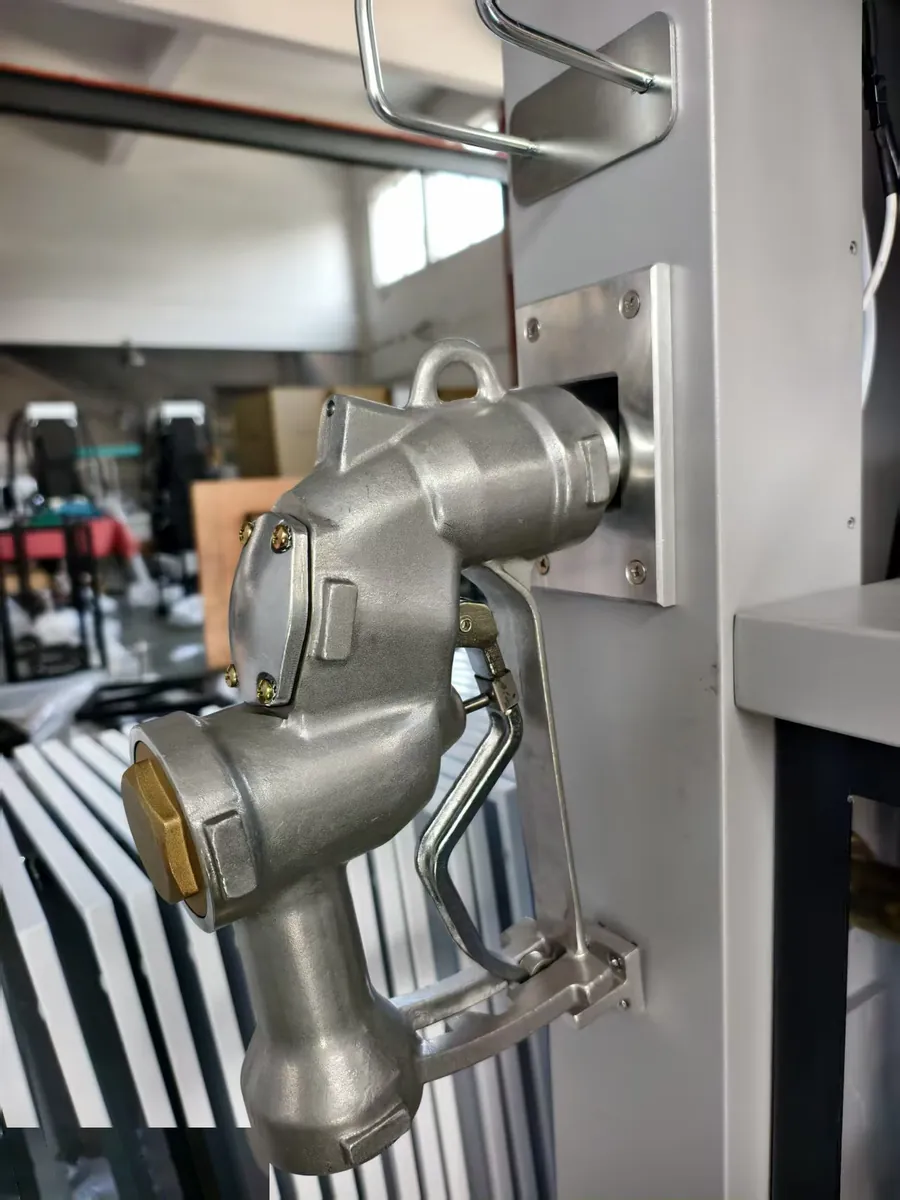 The 2-inch stainless high-flow nozzle on its hook beside the column