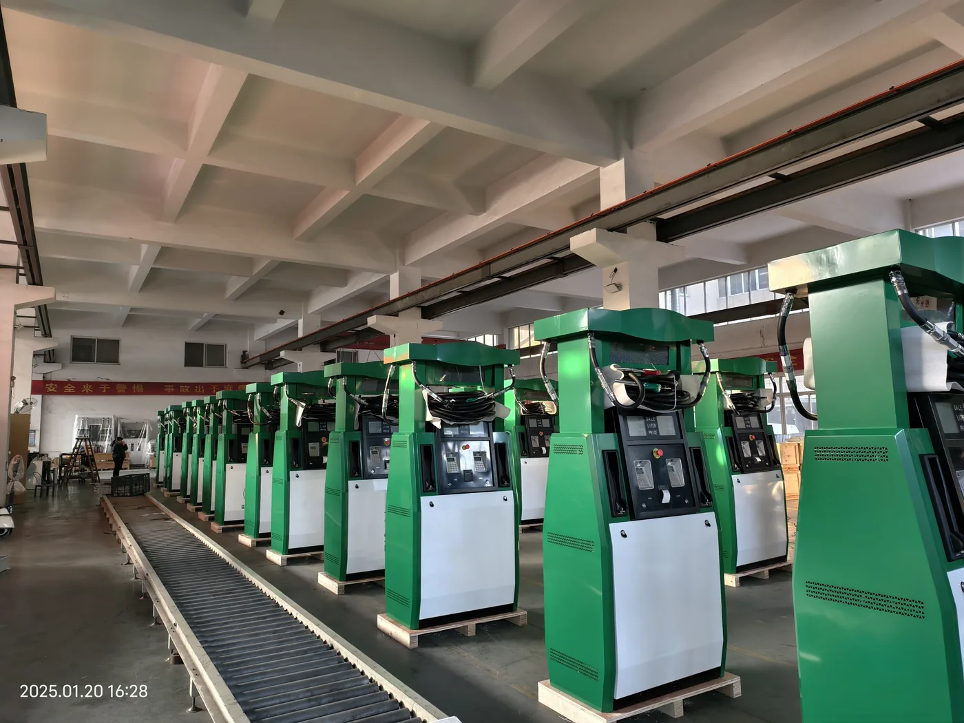 Row of green DT-G cabinets lined up on the assembly line