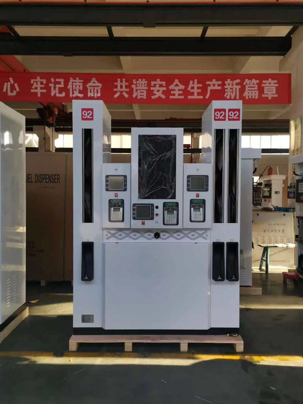 DT-M multimedia dispenser in the workshop, white cabinet with large central LED covered with protective film, three display panels on top
