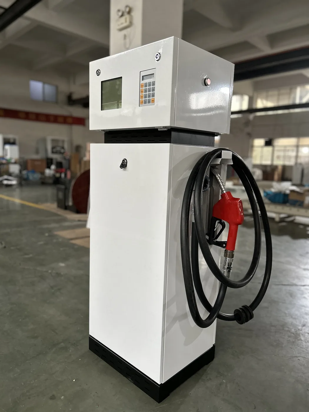 DT-T1 single-nozzle compact dispenser, white cabinet, workshop side view with red nozzle