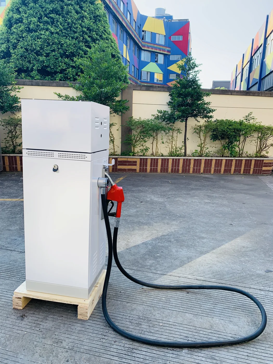 DT-T1 single-nozzle dispenser installed at a customer site, white cabinet on wooden pallet