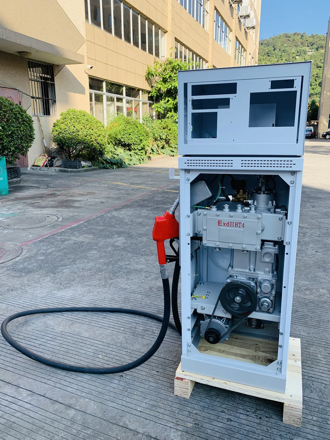 DT-T1 single-nozzle dispenser, white cabinet with front panel open showing internal pump and motor
