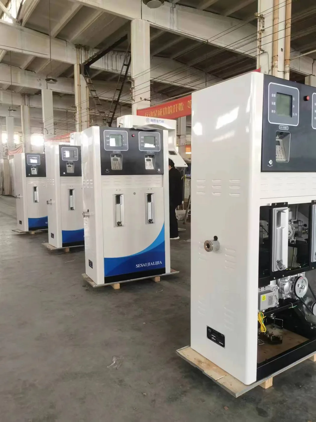 Row of DT-T2 dispensers staged in the workshop, white cabinets with SESAI JIALIJIA branding