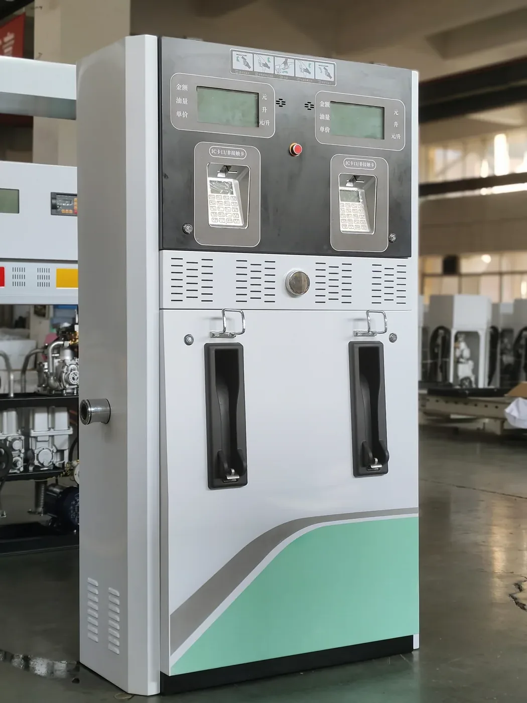 DT-T2 twin-nozzle dispenser, white cabinet with green wave accent, workshop front view with both display panels visible